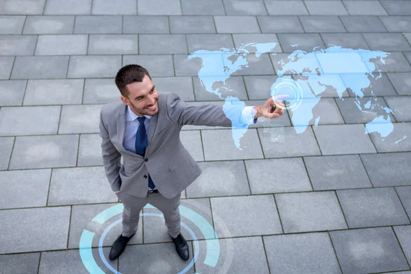 Sonriente hombre de negocios con proyección de mapa del mundo —  Fotos de Stock