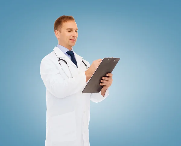 Smiling male doctor with clipboard and stethoscope — Stock Photo, Image