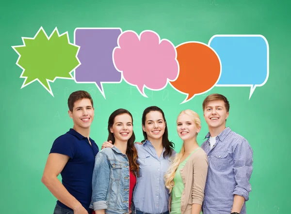 Group of smiling teenagers with text bubbles — Stock Photo, Image