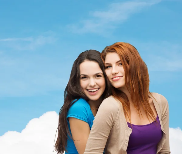 Smiling teenage girls hugging — Stock Photo, Image