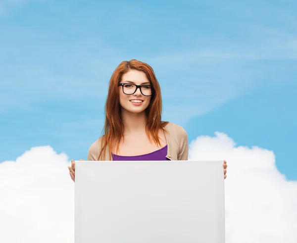 Smiling teenage girl in glasses with white board — Stock Photo, Image