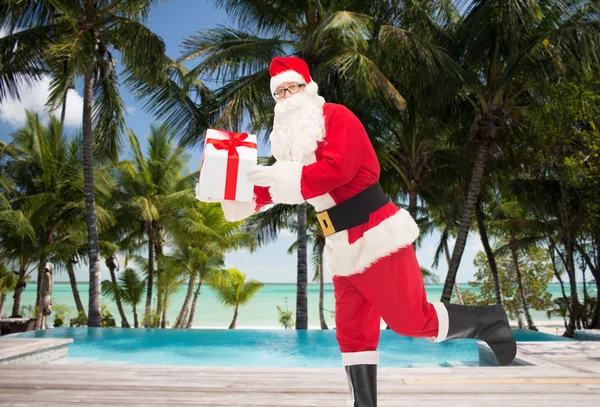 Man in costume of santa claus with gift box — Stock Photo, Image