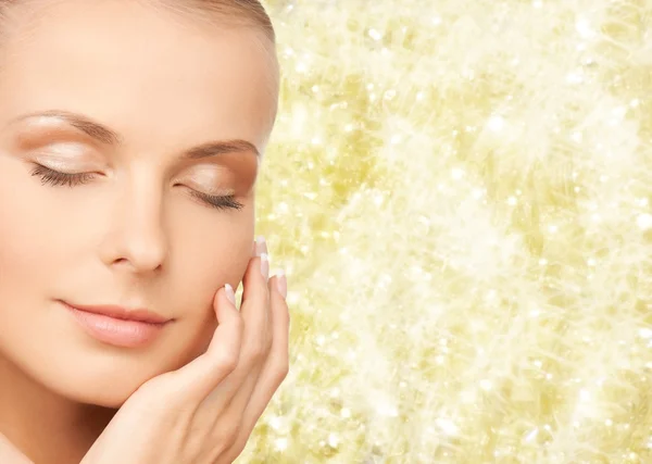 Beautiful young woman touching her face — Stock Photo, Image