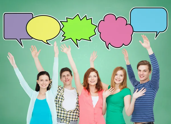 Group of smiling teenagers with text bubbles — Stock Photo, Image