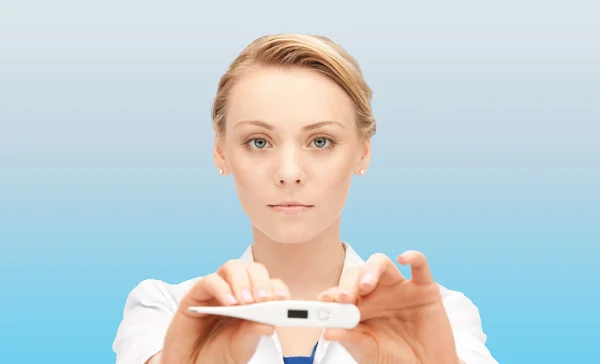 Young female doctor showing thermometer — Stock Photo, Image