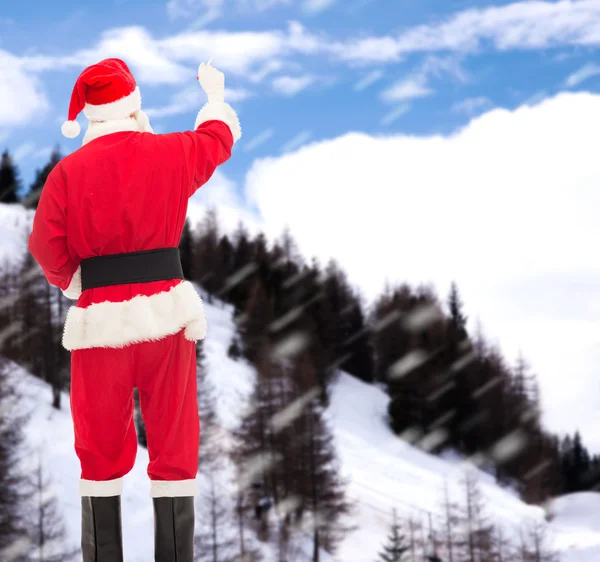 Man in costume of santa claus writing something — Stock Photo, Image