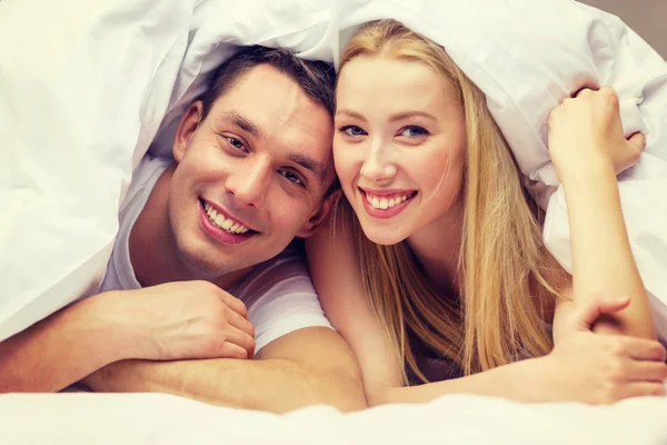 Happy couple sleeping in bed Stock Image