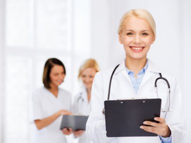 smiling female doctor with clipboard clipart