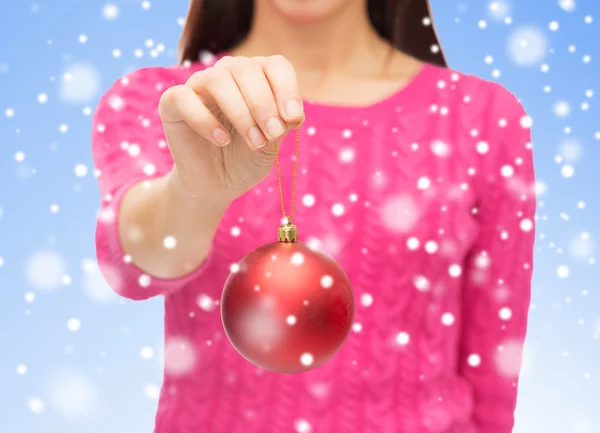 Close up of woman in sweater with Christmas ball — Stok Foto