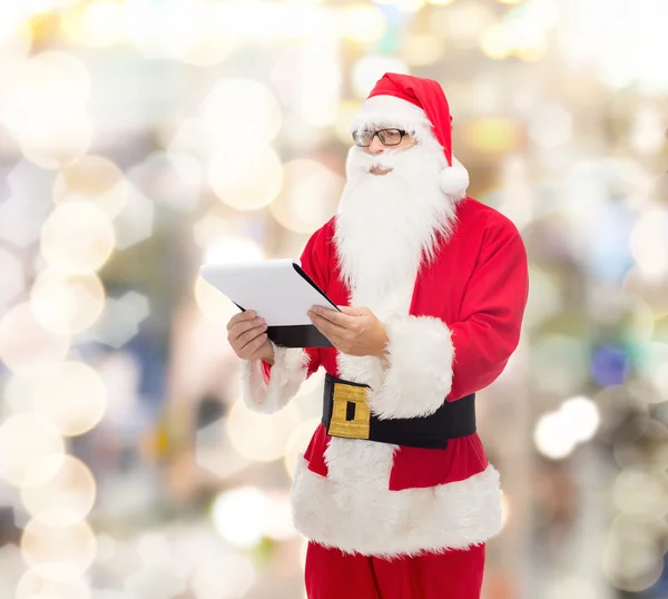 Man in costume of santa claus with notepad — Stock Photo, Image