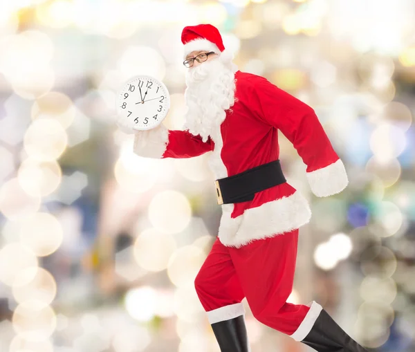 Man in costume of santa claus with clock — Stock Photo, Image