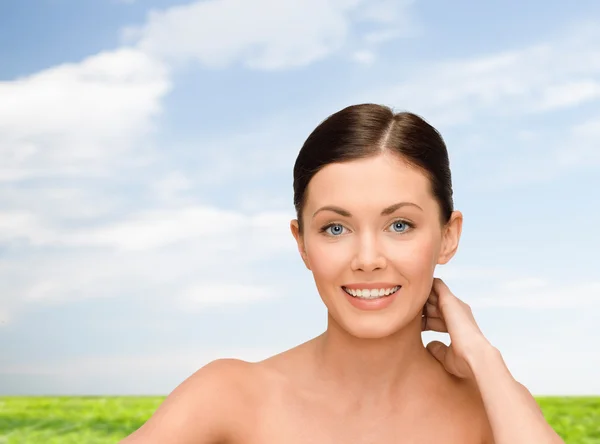 Smiling young woman with bare shoulders — Stock Photo, Image