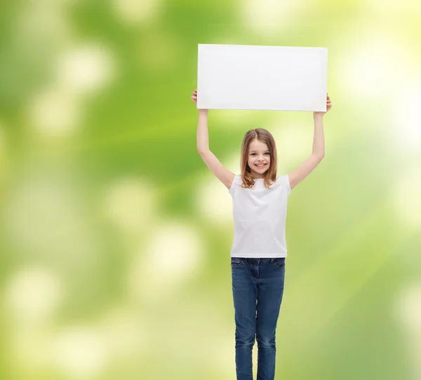 Smiling little girl holding blank white board — Stock Photo, Image
