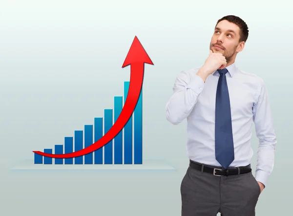 Thinking young businessman with growth chart — Stock Photo, Image