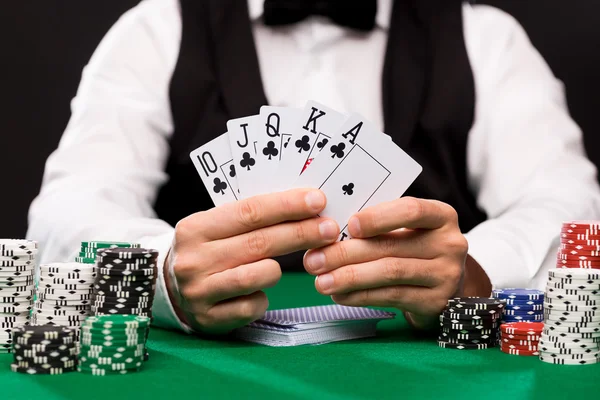 Poker player with cards and chips at casino — Stock Photo, Image