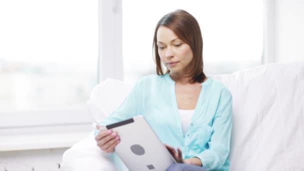 Calm woman with tablet pc computer at home — Stock Video