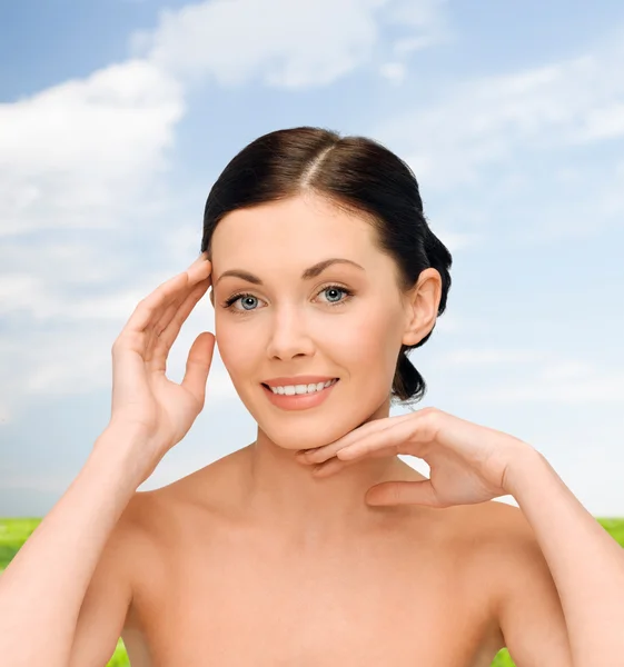 Smiling young woman with bare shoulders — Stock Photo, Image