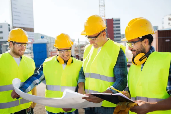 Group of builders with tablet pc and blueprint — Stock Photo, Image