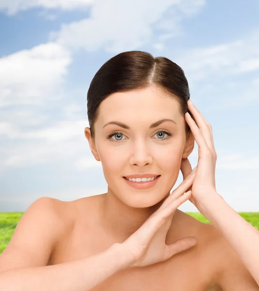 Smiling young woman with bare shoulders — Stock Photo, Image