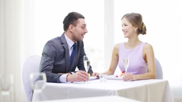 Smiling couple with champagne at restaurant — Stock Video