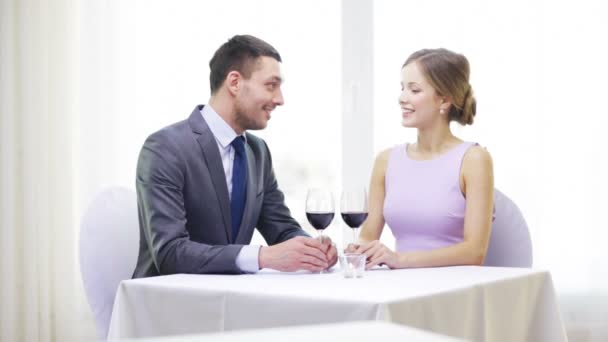 Young couple with glasses of wine at restaurant — Stock Video