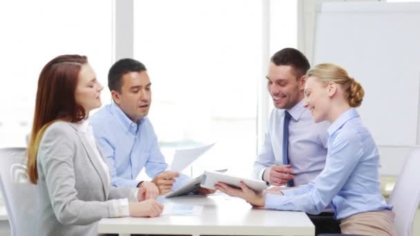 Smiling team with table pc and papers working — Stock Video