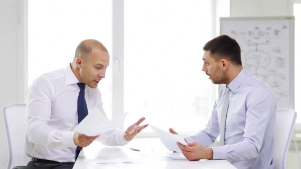 Two serious businessmen with charts in office — Stock Video