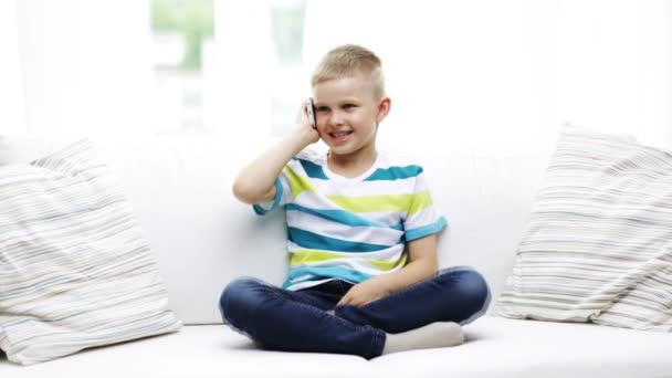 Smiling schoolboy with smartphone at home — Stock Video