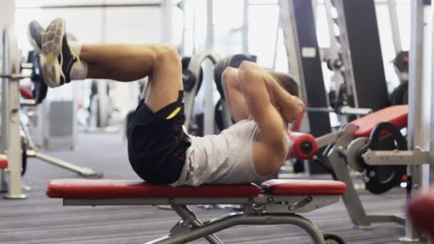 Joven con mancuerna en el gimnasio — Vídeos de Stock