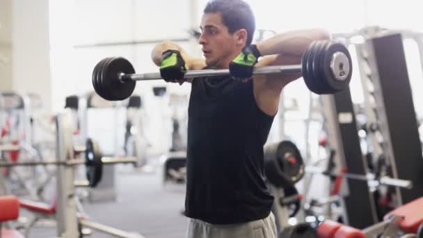 Young man with dumbbell in gym — Stock Footage Young man with dumbbell in gym Royalty Free Stock Video