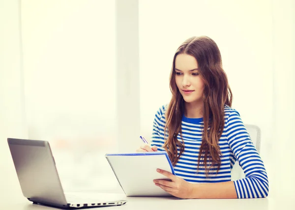 Teenage girl laptop computer and notebook Stock Photo