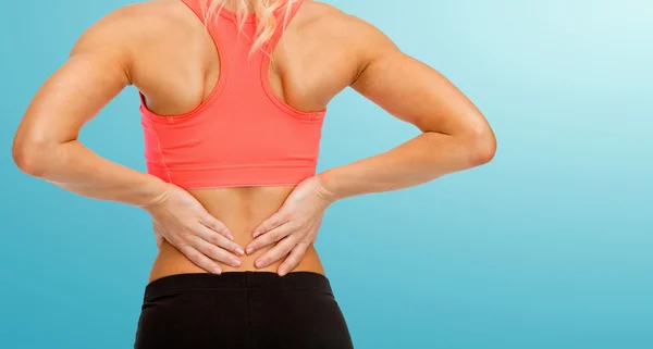 Close up of sporty woman touching her back Stock Picture