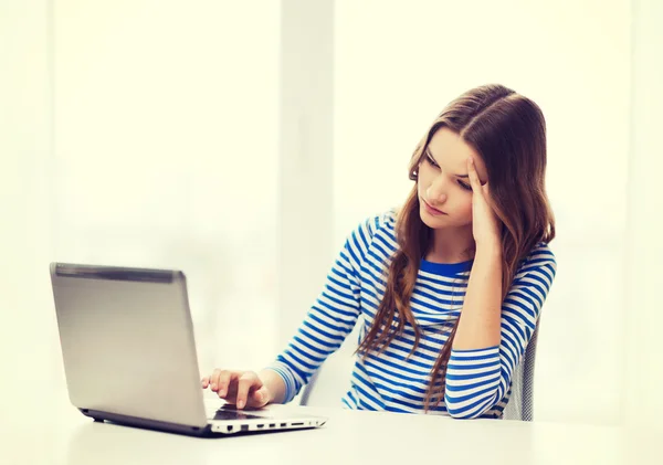 Upset teenage gitl with laptop computer at home — Stock Photo, Image