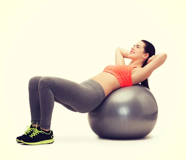 Teenage girl doing exercise on fitness ball — Stock Photo, Image