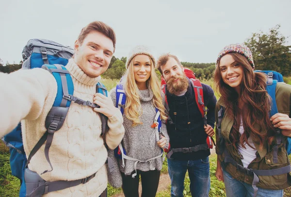 Hiking sırt çantaları ile gülümseyen arkadaş grubu — Stok fotoğraf