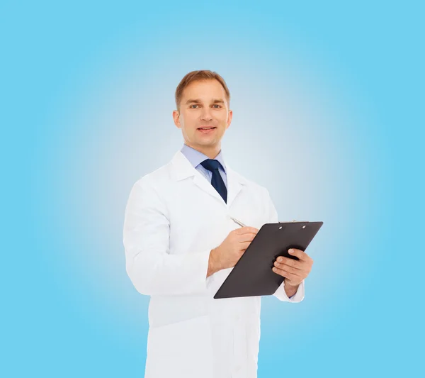 Smiling male doctor with clipboard — Stock Photo, Image