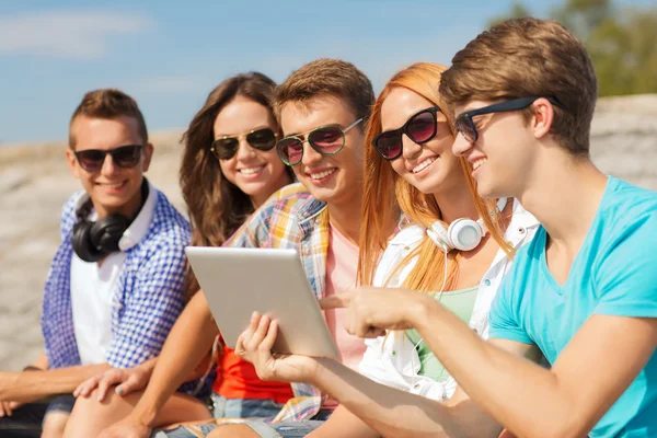 Grupo de amigos sonrientes con tableta PC al aire libre — Foto de Stock