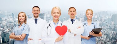 group of smiling doctors with red heart shape clipart