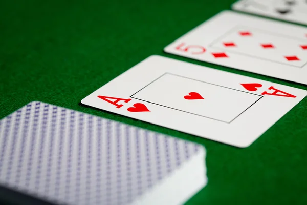 Close up of playing cards on green table surface — Stock Photo, Image