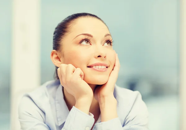 Smiling businesswoman dreaming in office — Stock Photo, Image