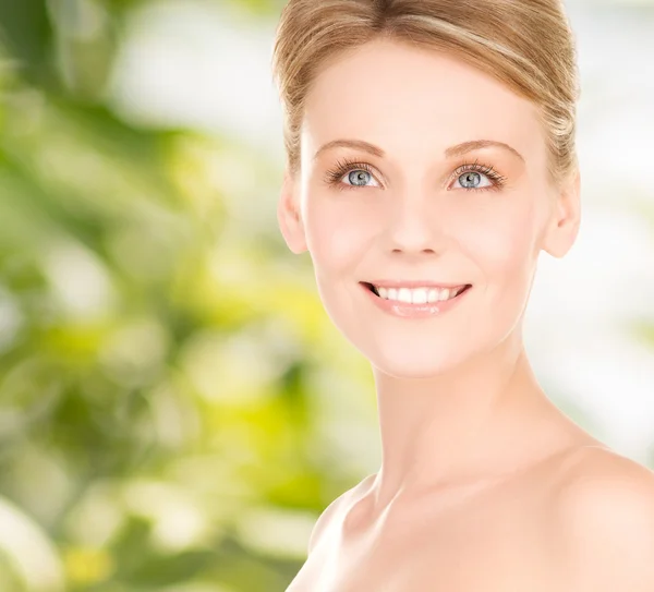 Close up of smiling woman over green background — Stock Photo, Image