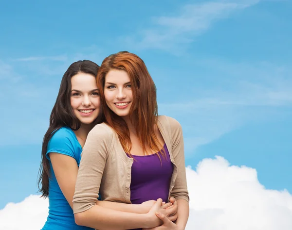 Smiling teenage girls hugging — Stock Photo, Image