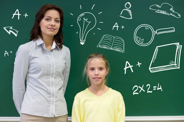 Liten skolflicka med lärare på blackboard — Stockfoto