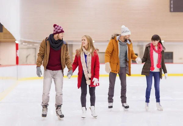 Happy friends on skating rink — Stock Photo, Image