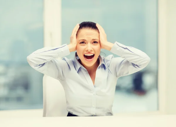 Angry screaming businesswoman in office Stock Photo
