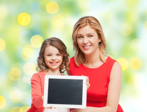 Mother and daughter with tablet pc over green — Stock Photo, Image
