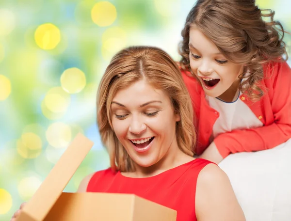 Feliz madre e hija abriendo caja de regalo —  Fotos de Stock