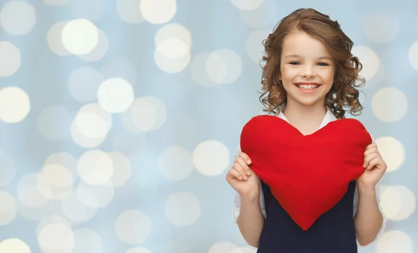 Smiling little girl with red heart — Stock Photo, Image