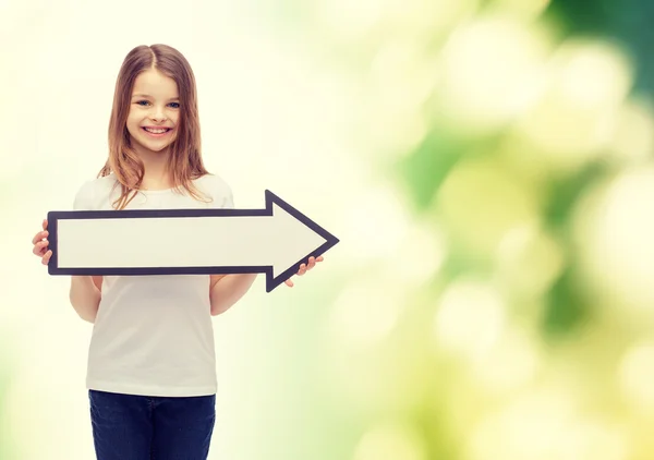Smiling girl with blank arrow pointing right — Stock Photo, Image