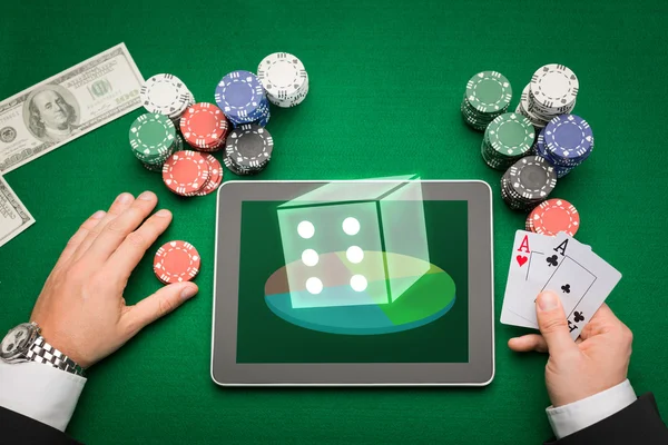 Casino poker player with cards, tablet and chips — Stock Photo, Image